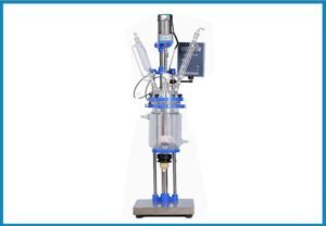 Scientist operating Equilrxnlab’s pilot scale glass reactor during controlled synthesis, demonstrating advanced lab-scale process capabilities.